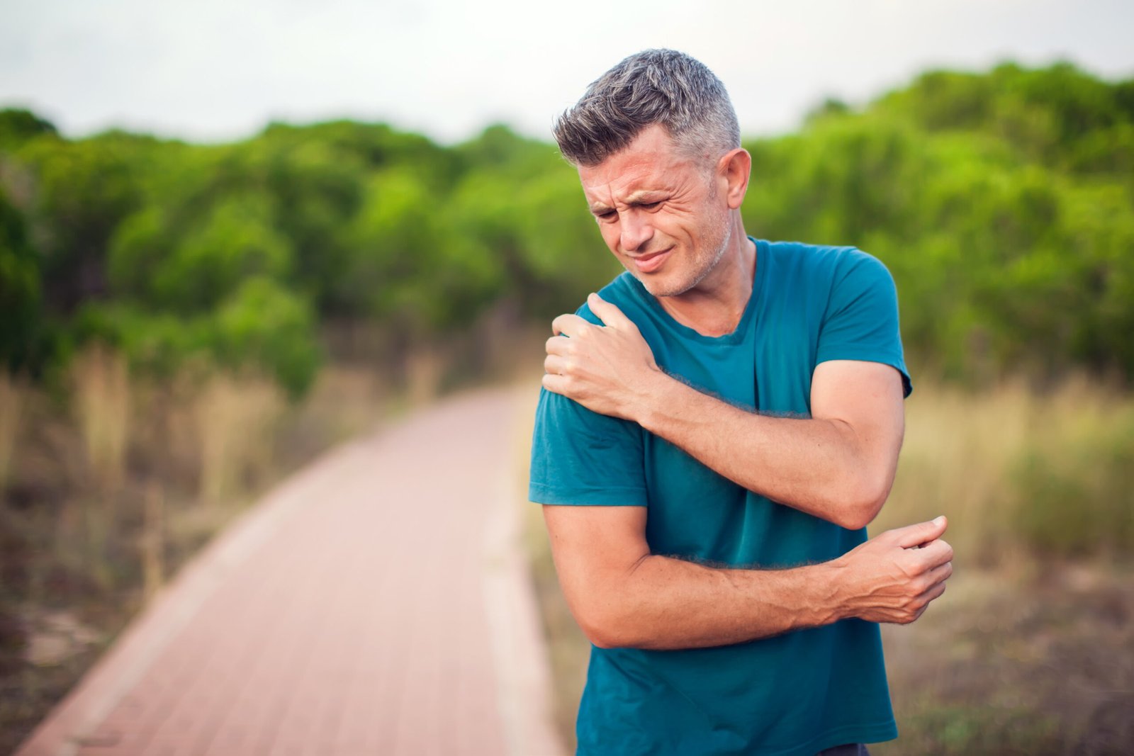 Shoulder,Pain.,Man,With,Arm,Injury,Outdoor.,Healthcare,And,Medicine